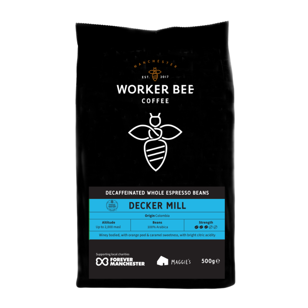 A 500g bag of Decker Mill Decaf Espresso Beans by Worker Bee Tea & Coffee, Swiss Water processed, chemical free, Colombian origin. Features tasting notes and strength, with a stylized bee logo on the packaging.