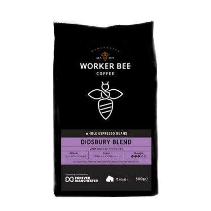 Black coffee bag with 'Manchester Worker Bee Coffee' branding and Didsbury Blend label on a white background