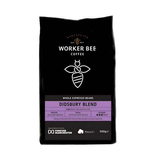 Black coffee bag with 'Manchester Worker Bee Coffee' branding and Didsbury Blend label on a white background