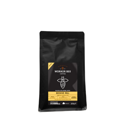Black coffee packaging with yellow accents featuring the 'Manchester Worker Bee Coffee' brand on a white background.