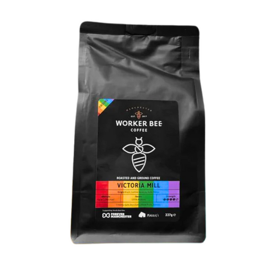 A 227g black bag of Worker Bee Tea & Coffees Victoria Mill Ground for Filter & Cafetierre, featuring a bee logo and rainbow label. This well-balanced blend uses premium roasted Arabica beans.