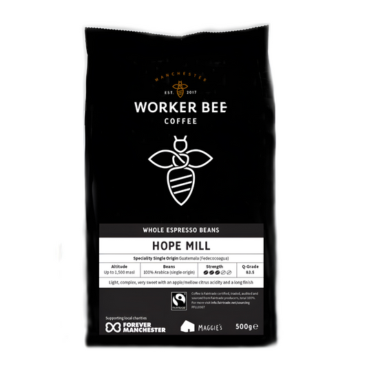 A 500g bag of Worker Bee Tea & Coffees Hope Mill Guatemalan Single Origin Speciality Coffee, whole beans, features a bee logo. Highlights include high-altitude microlot beans, strong flavour, and support for charity initiatives.