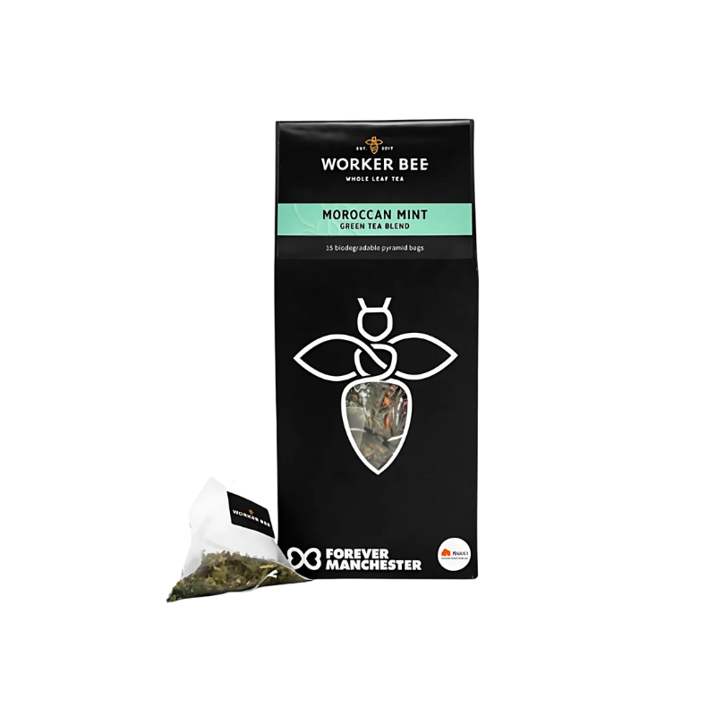 A black box of Worker Bee Tea & Coffee Moroccan Mint Tea Sacks (15), featuring a bee logo and a pyramid tea bag with loose leaf gunpowder green tea on display. The package highlights Forever Manchester.