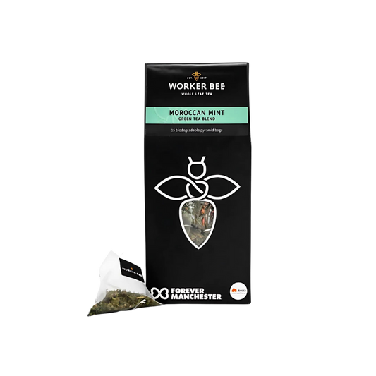 A black box of Worker Bee Tea & Coffee Moroccan Mint Tea Sacks (15), featuring a bee logo and a pyramid tea bag with loose leaf gunpowder green tea on display. The package highlights Forever Manchester.