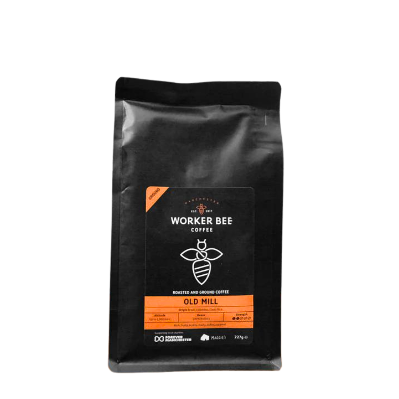 Black coffee bag with 'Manchester Worker Bee Coffee' branding on a white background