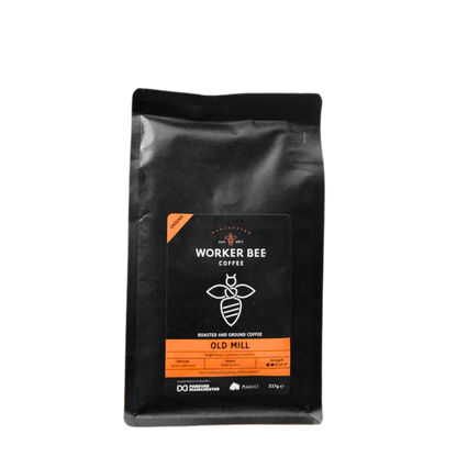 Black coffee bag with 'Manchester Worker Bee Coffee' branding on a white background